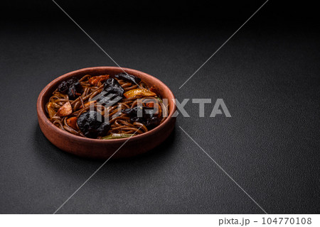 Delicious fresh buckwheat noodles or udon with mushrooms, peppers and other vegetables Delicious fresh buckwheat noodles or udon with mushrooms, peppers and other vegetables 104770108