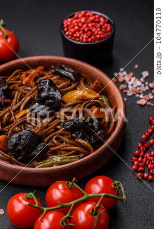 Delicious fresh buckwheat noodles or udon with mushrooms, peppers and other vegetables 104770119