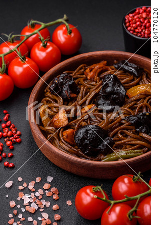 Delicious fresh buckwheat noodles or udon with mushrooms, peppers and other vegetables Delicious fresh buckwheat noodles or udon with mushrooms, peppers and other vegetables 104770120