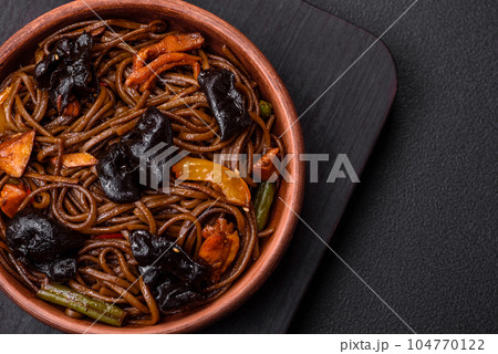 Delicious fresh buckwheat noodles or udon with mushrooms, peppers and other vegetables Delicious fresh buckwheat noodles or udon with mushrooms, peppers and other vegetables 104770122