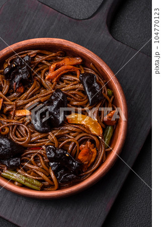 Delicious fresh buckwheat noodles or udon with mushrooms, peppers and other vegetables Delicious fresh buckwheat noodles or udon with mushrooms, peppers and other vegetables 104770123