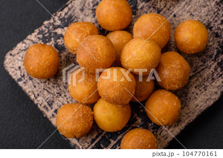Delicious fried potato balls with breaded mozzarella, salt, spices and herbs Delicious fried potato balls with breaded mozzarella, salt, spices and herbs 104770161