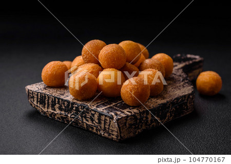 Delicious fried potato balls with breaded mozzarella, salt, spices and herbs 104770167