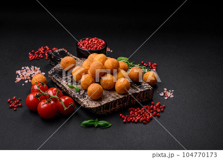 Delicious fried potato balls with breaded mozzarella, salt, spices and herbs Delicious fried potato balls with breaded mozzarella, salt, spices and herbs 104770173