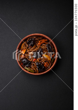 Delicious fresh buckwheat noodles or udon with mushrooms, peppers and other vegetables 104770300