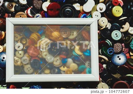 White blur frame on scattered different buttons of a tailor in a shop 104772607