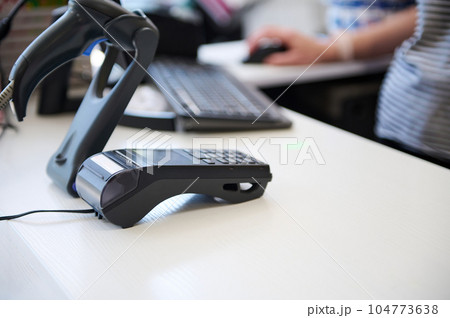 Selective focus. A countertop with credit card reader and barcode scanner in a store. Selective focus. A countertop with credit card reader and barcode scanner in a store. 104773638