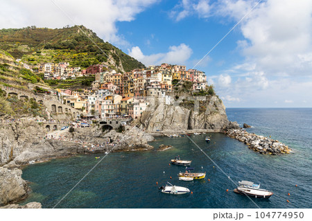 Scenic view of Manarola village, one of the five villages along Cinque Terre hiking trail in Italy, popular as tourist destination 104774950