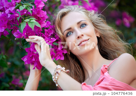 Close-Up Portrait of Blonde Woman Posing In The Park 104776436
