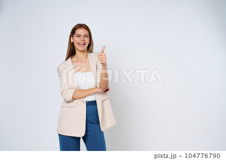 Young woman pointing to empty copy space isolated on white background. Young woman pointing to empty copy space isolated on white background. 104776790