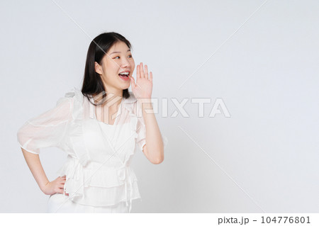 Portrait of young woman with open mouths raising hands screaming announcement isolated on white background. 104776801