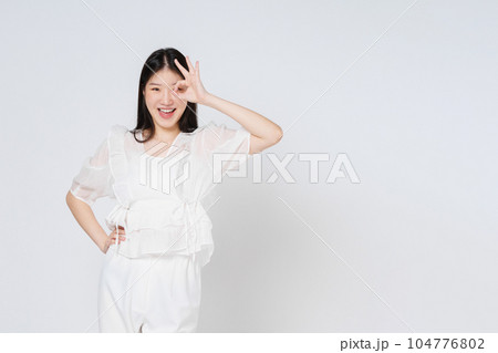 Young woman standing and thinking with serious face isolated on white background. 104776802