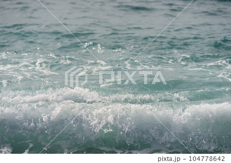 Closeup of coastline wave on mediterranean coast 104778642