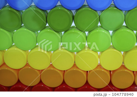 Multi-colors background of plastic drinking water caps. 104778940