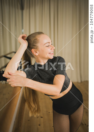 Active young woman portrait female ballet or contemporary dance teacher class in studio 104779008