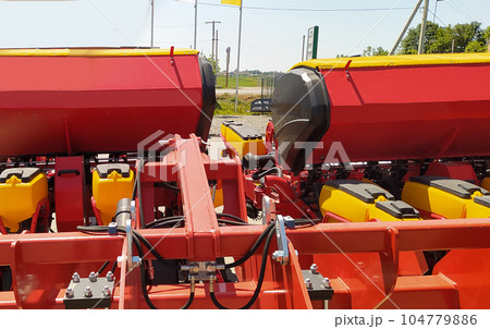 The colorful red seeder on the ground 104779886