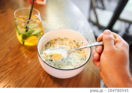 okroshka is a traditional dish of national Russian cuisine, vegetables with meat and kvass, cold soup. okroshka is a traditional dish of national Russian cuisine, vegetables with meat and kvass, cold soup. 104780545