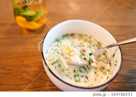 okroshka is a traditional dish of national Russian cuisine, vegetables with meat and kvass, cold soup. okroshka is a traditional dish of national Russian cuisine, vegetables with meat and kvass, cold soup. 104780551