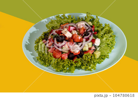 Salad with lettuce, chicken, cherry tomatoes and eggs. Seasoned with sauce. On a colored background. 104780618