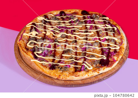 Pizza with bacon cheese and herbs on a wooden plate with cheese and cherry tomatoes. On a colored background. Pizza with bacon cheese and herbs on a wooden plate with cheese and cherry tomatoes. On a colored background. 104780642
