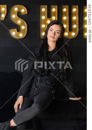 Beautiful brutal woman in black on dark interiorの写真素材 [104781016] - PIXTA