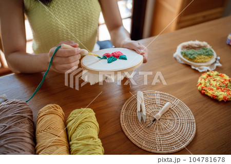 Punch needle. Asian Woman making handmade Hobby knitting in studio workshop. designer workplace Handmade craft project DIY embroidery concept. Punch needle. Asian Woman making handmade Hobby knitting in studio workshop. designer workplace Handmade craft project DIY embroidery concept. 104781678