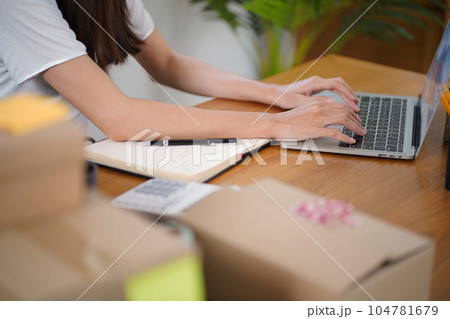 Business From Home Asian woman preparing package delivery box Shipping for shopping online. young start up small business owner at home online order Business From Home Asian woman preparing package delivery box Shipping for shopping online. young start up small business owner at home online order 104781679