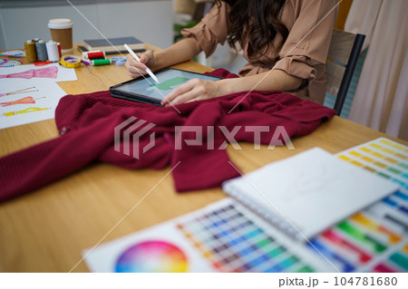 Tailor woman working in tailor shop Stylish Fashion designer tailor in workshop studio designing new collection Dressmaking and Creative.fashion collection. 104781680