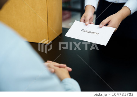 Business woman sending resignation letter to boss and Holding Stuff Resign Depress or carrying cardboard box by desk in office Business woman sending resignation letter to boss and Holding Stuff Resign Depress or carrying cardboard box by desk in office 104781702
