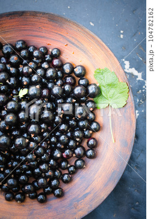 black currants in a large wooden bowl black currants in a large wooden bowl 104782162