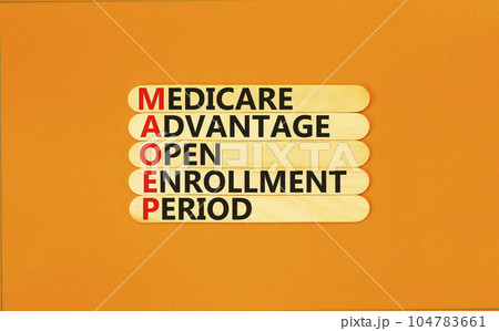 MAOEP symbol. Concept words MAOEP medicare advantage open enrollment period on wooden stick. Beautiful orange background. Medical MAOEP medicare advantage open enrollment period concept. Copy space. 104783661