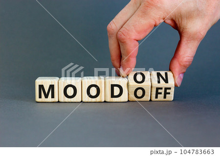 Mood on or off symbol. Businessman turns wooden cubes and changes word Mood off to Mood on. Beautiful grey table grey background. Business and mood on or off concept. Copy space. Mood on or off symbol. Businessman turns wooden cubes and changes word Mood off to Mood on. Beautiful grey table grey background. Business and mood on or off concept. Copy space. 104783663