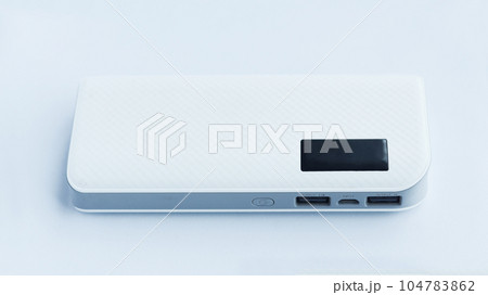 A white flat power bank isolated on white background with two usb output and one input socket electrical source. 104783862