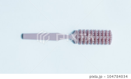 Woman stylish pink hair comb used for thick hair. 104784034