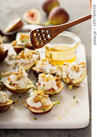 Fall appetizer with figs, feta cheese and walnuts 104784549
