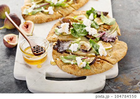Fall flatbread pizza with fresh figs and goat cheese Fall flatbread pizza with fresh figs and goat cheese 104784550