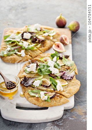 Fall flatbread pizza with fresh figs and goat cheese Fall flatbread pizza with fresh figs and goat cheese 104784551