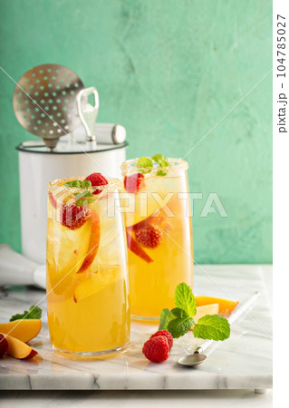 Colorful refreshing cold summer drink with peaches Colorful refreshing cold summer drink with peaches 104785027