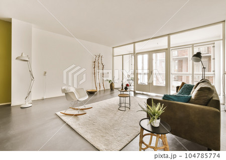 a living room with couches, chairs and a large window looking out onto the street in front of it a living room with couches, chairs and a large window looking out onto the street in front of it 104785774