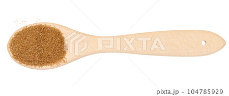 Wooden spoon with brown cane sugar on a white background, top view Wooden spoon with brown cane sugar on a white background, top view 104785929