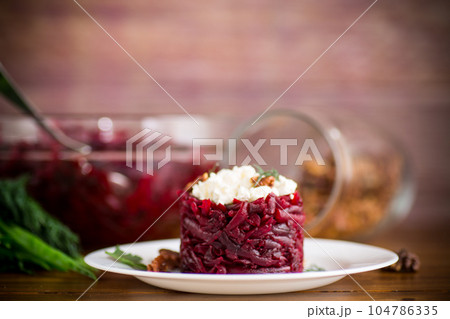 dietary salad of boiled beets with walnuts and cottage cheese 104786335