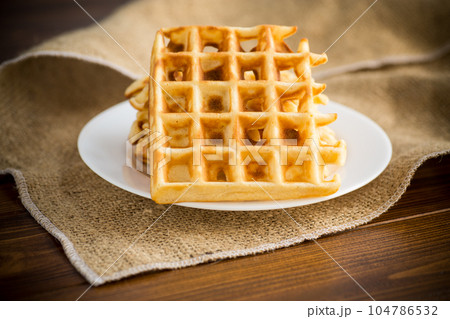sweet cooked aromatic Belgian waffles in a plate 104786532