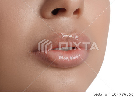 Young woman with beautiful full lips on white background, closeup 104786950