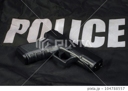Police hand gun on black uniform 104788557