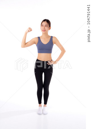 Portrait of beautiful young asian woman in sportwear showing strong muscles isolated. Portrait of beautiful young asian woman in sportwear showing strong muscles isolated. 104791441