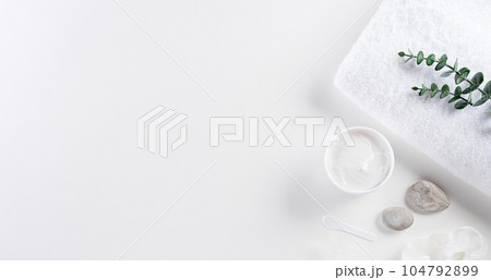 Cosmetic bottle containers, skin cream with flowers. Natural beauty and spa concept, Top view on white table background. Cosmetic bottle containers, skin cream with flowers. Natural beauty and spa concept, Top view on white table background. 104792899