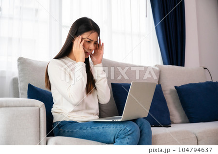 Office syndrome. Overworked tired young asian woman feeling headache 104794637