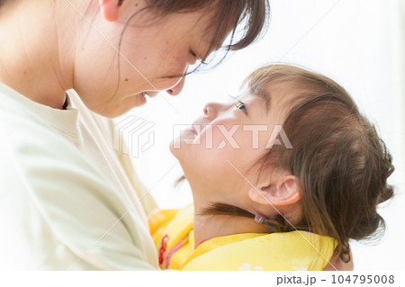 七五三の着物を着た女の子を抱きしめるお母さん 104795008