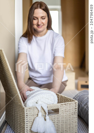 An unknown neat housewife lays out her underwear in the drawers of the wardrobe. The concept of organizing space and storing clothes. 104796489