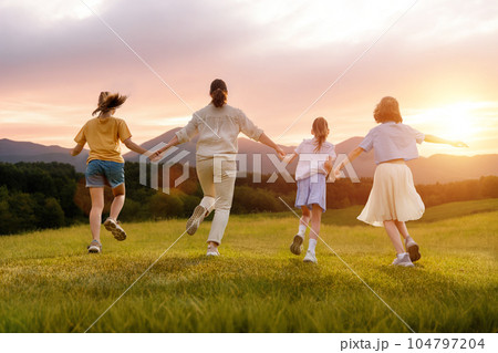 Happy family at sunset 104797204